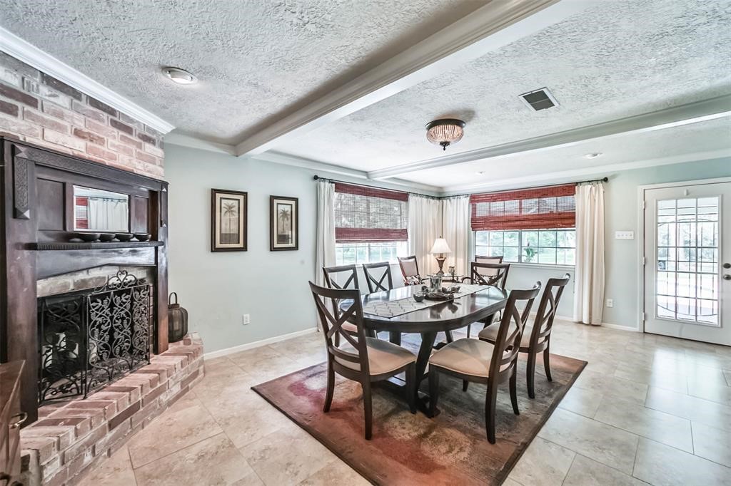 6911 Sprigg Street Fulshear, TX 77441 - Photo 18 of 48 a view of a dining room with furniture and wooden floor