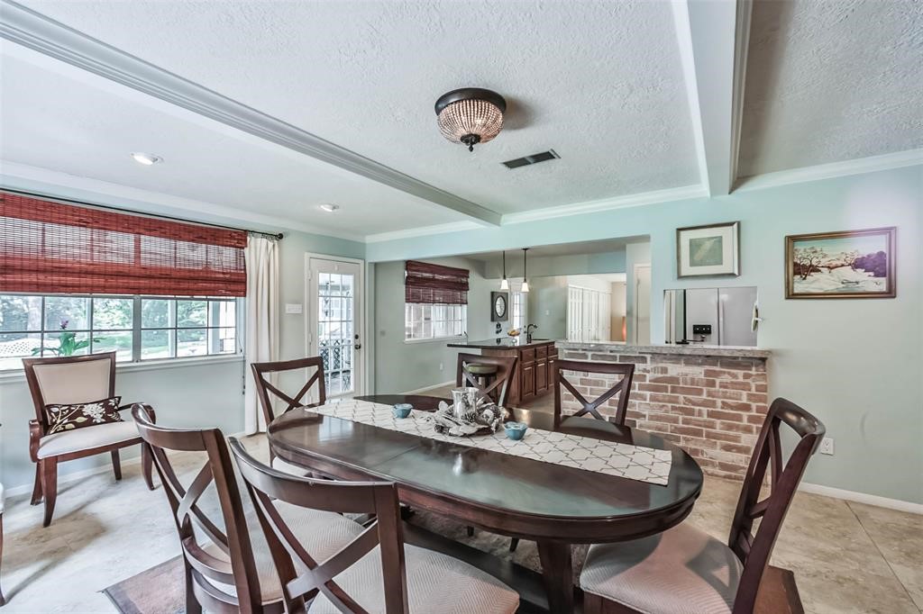 6911 Sprigg Street Fulshear, TX 77441 - Photo 19 of 48 a view of a dining room with furniture and window