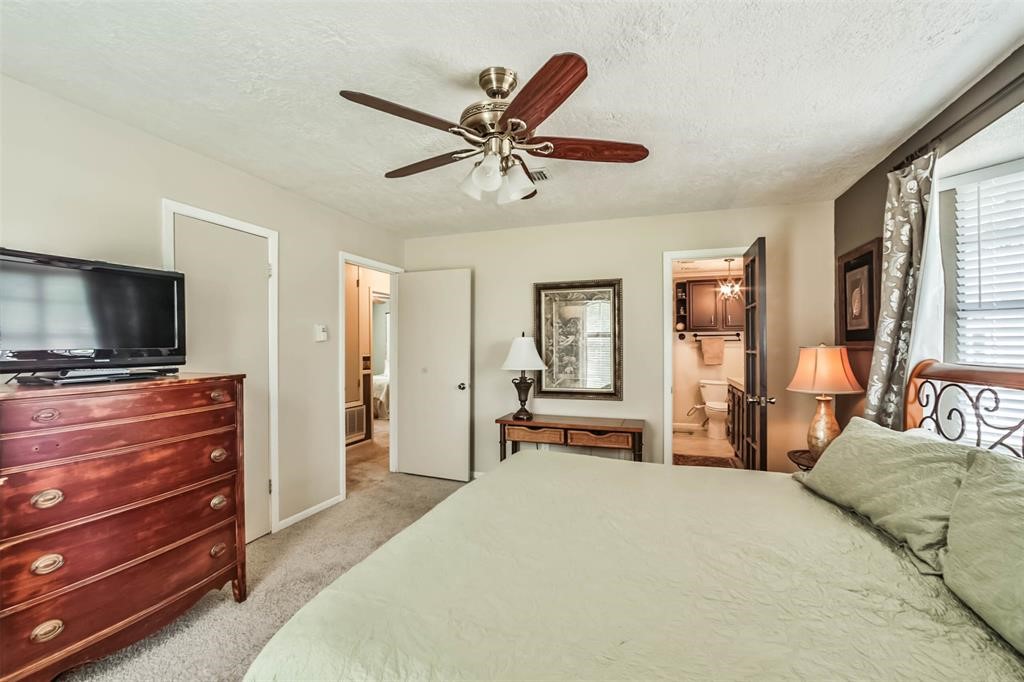 6911 Sprigg Street Fulshear, TX 77441 - Photo 21 of 48 a bedroom with a bed and a flat screen tv