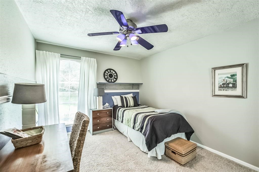 6911 Sprigg Street Fulshear, TX 77441 - Photo 25 of 48 a bedroom with a bed and window