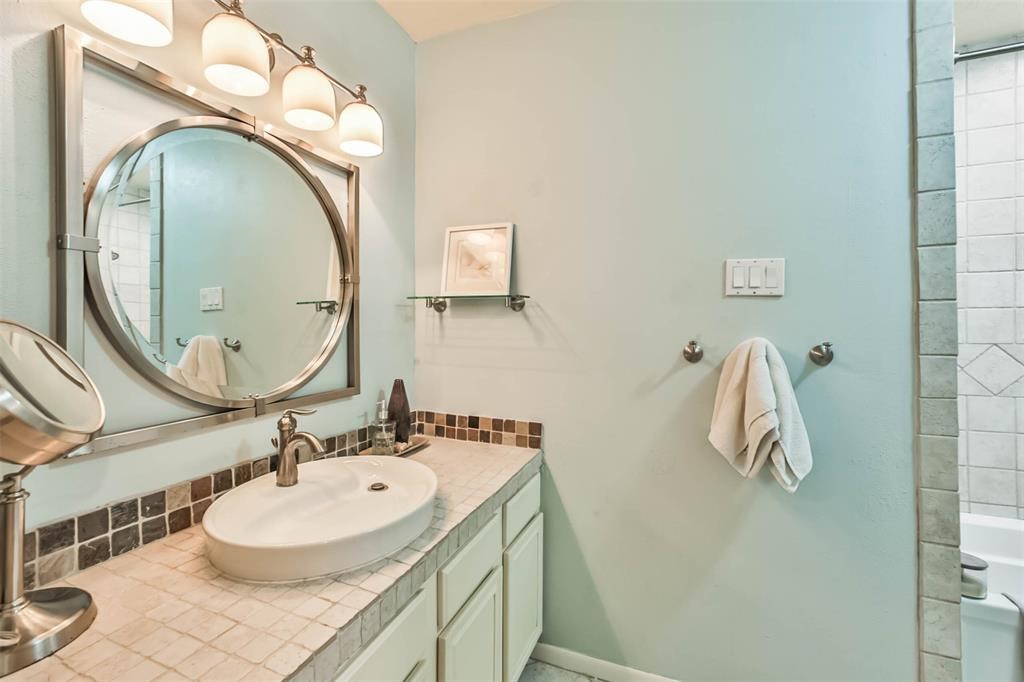 6911 Sprigg Street Fulshear, TX 77441 - Photo 27 of 48 a bathroom with a sink and a mirror