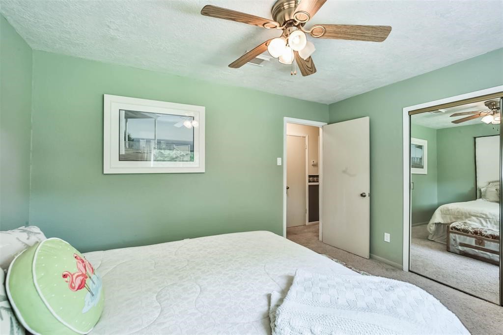 6911 Sprigg Street Fulshear, TX 77441 - Photo 30 of 48 a bedroom with a bed and a chandelier