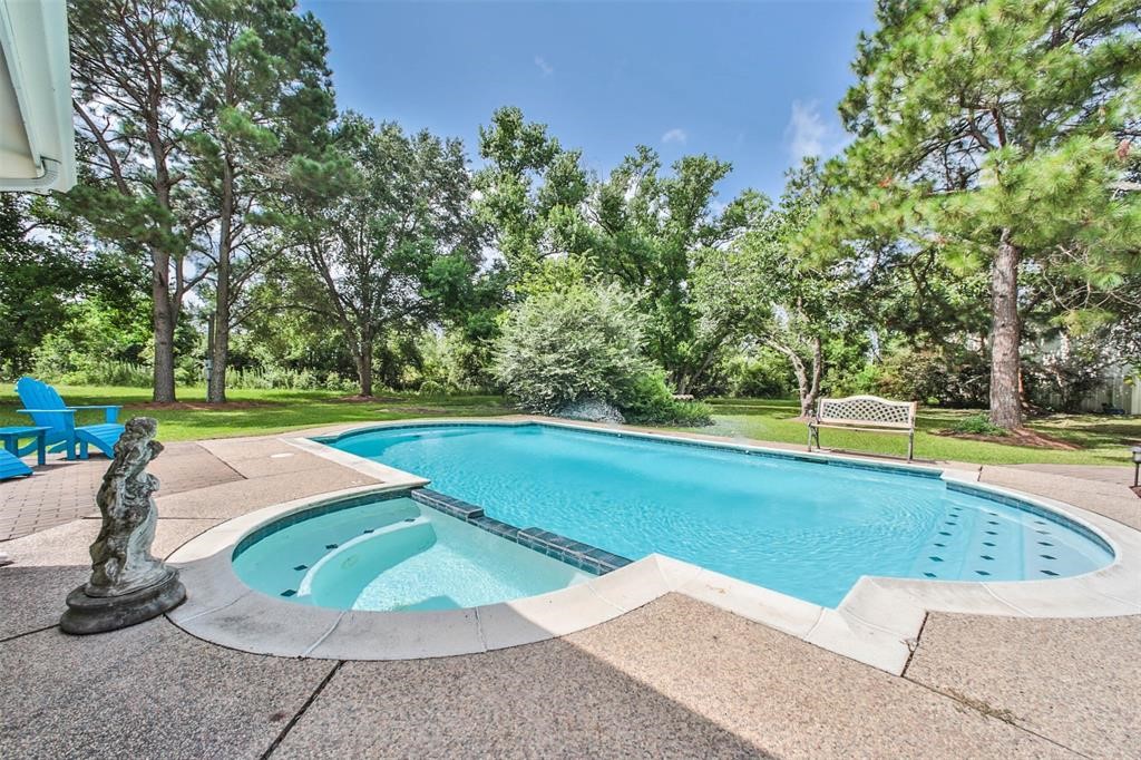 6911 Sprigg Street Fulshear, TX 77441 - Photo 3 of 48 a view of a swimming pool with a yard