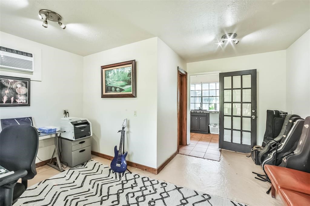 6911 Sprigg Street Fulshear, TX 77441 - Photo 37 of 48 a view of a workspace with furniture and a window