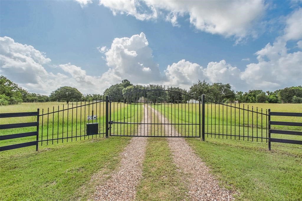 6911 Sprigg Street Fulshear, TX 77441 - Photo 48 of 48 a view of a yard with wooden fence