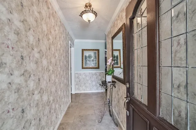 a large white kitchen with cabinets a sink a window and a refrigerator