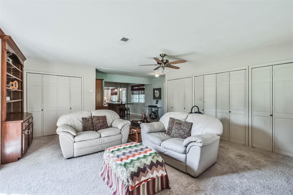 6911 Sprigg Street Fulshear, TX 77441 - Photo 9 of 48 a living room with furniture and a ceiling fan