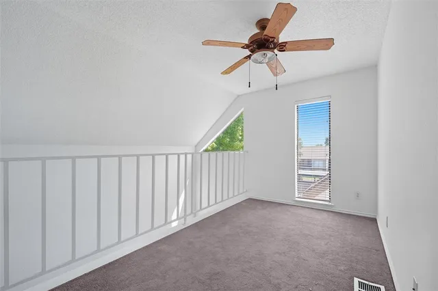 a view of a livingroom with a ceiling fan and window