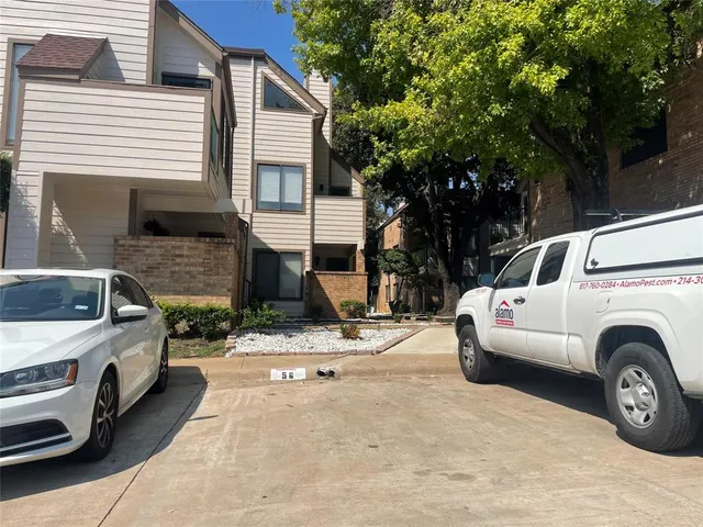 a view of a car parked in front of a house