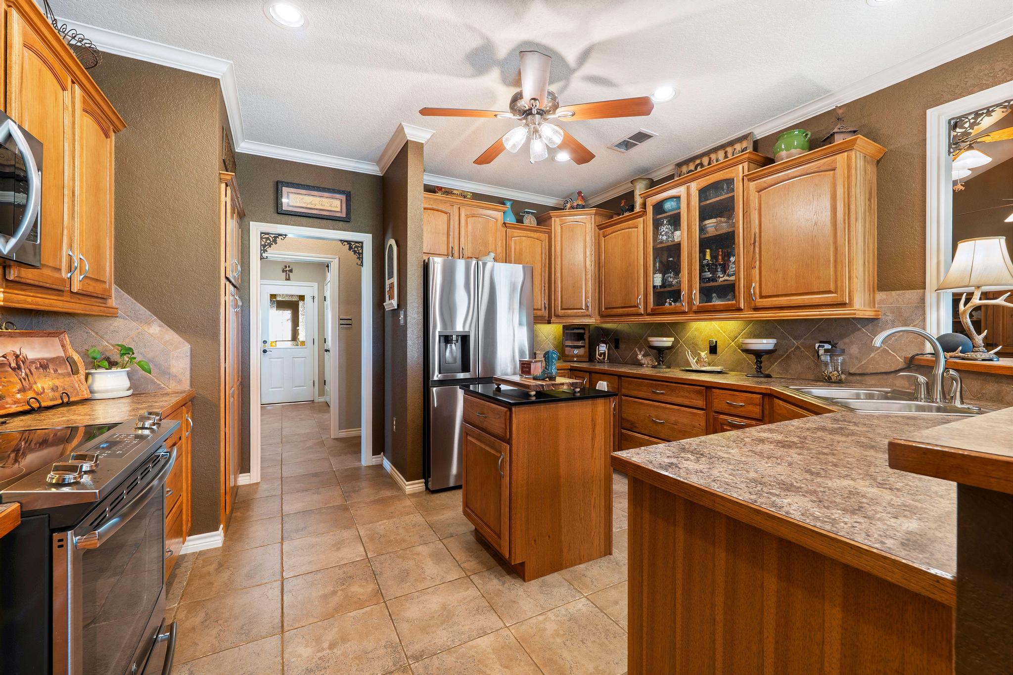 19000 Farm To Market Road 971 Granger, TX 76530 - Photo 13 of 40 The kitchen features a center island, ample cabinet and counter space, and stainless steel appliances.