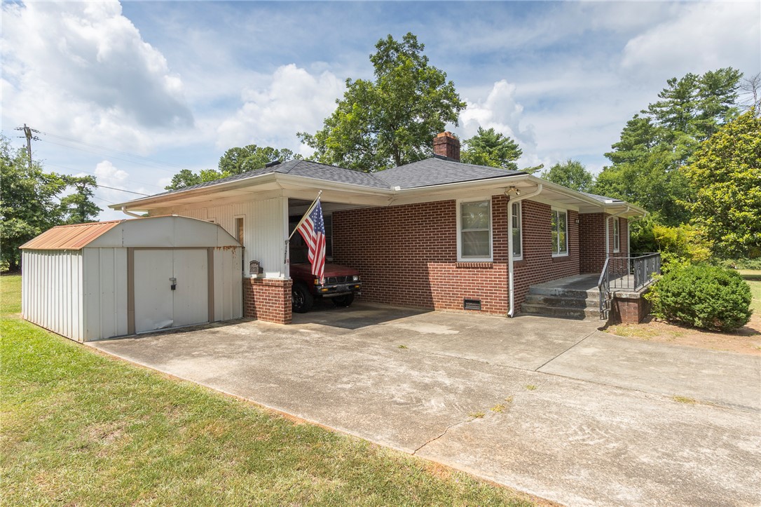 1218 Bolt Drive Anderson, SC 29621 - Photo 43 of 46 Brick facade home offers ample parking, a convenient carport, and a useful storage shed.