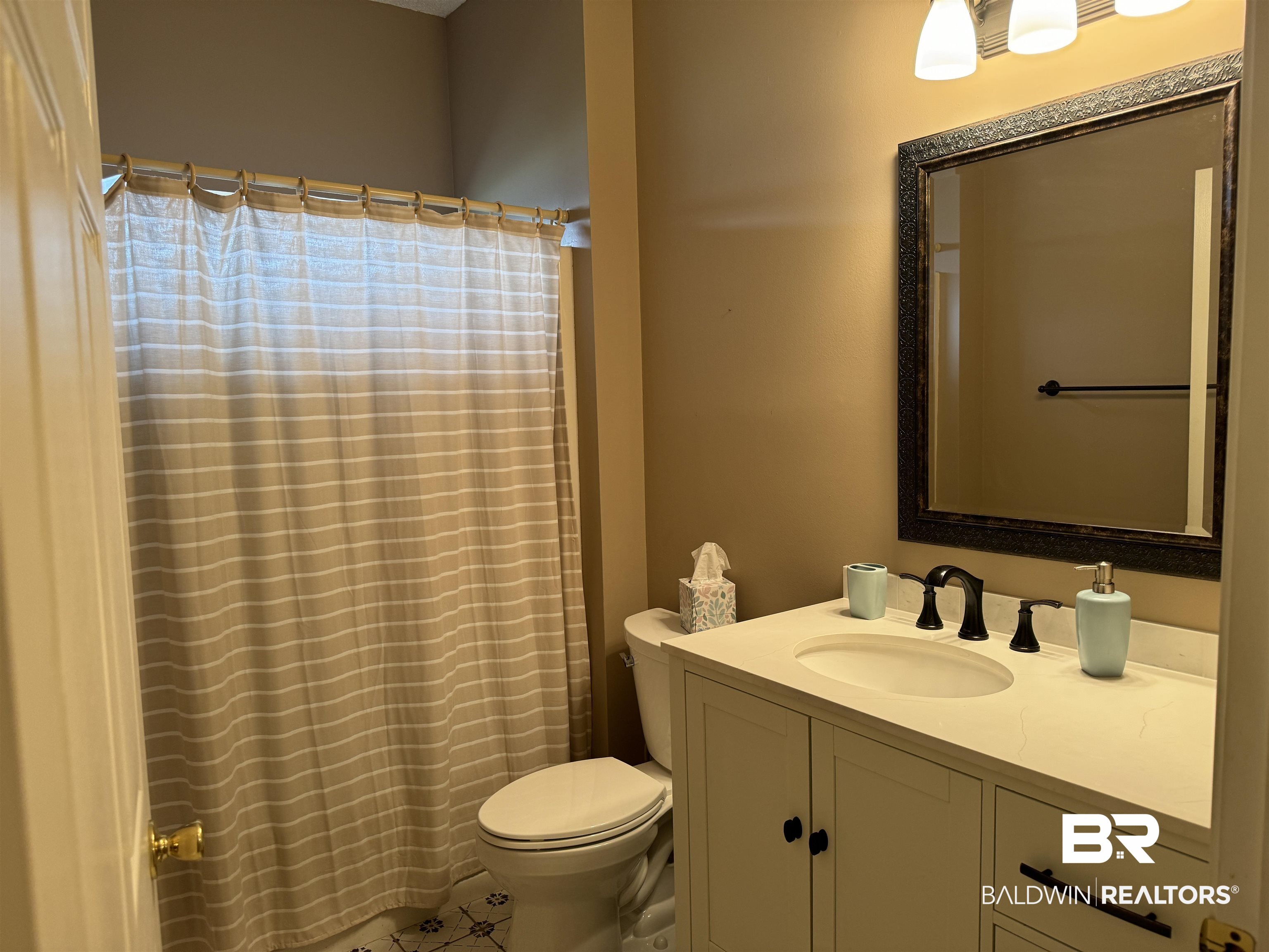 9139 Clubhouse Drive Foley, AL 36535 - Photo 27 of 30 Bathroom with vanity, tile patterned floors, and toilet