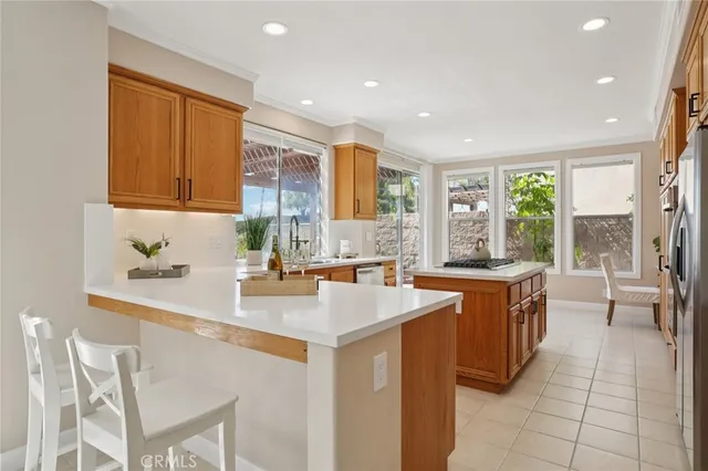 a kitchen with stainless steel appliances granite countertop a sink and a refrigerator
