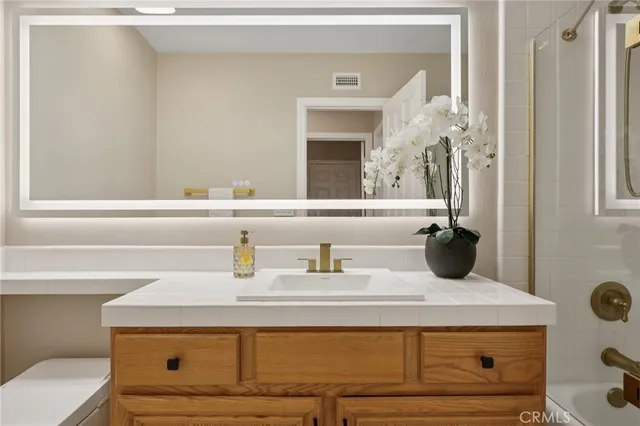 a bathroom with a sink and mirror