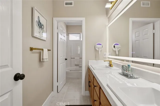 a bedroom with a bed and painting on the wall