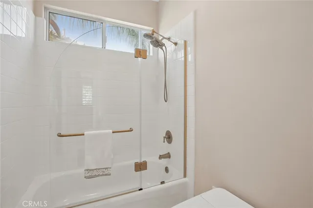 a bedroom with a bed and painting on the wall