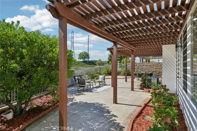a view of a patio with couches table and chairs and potted plants
