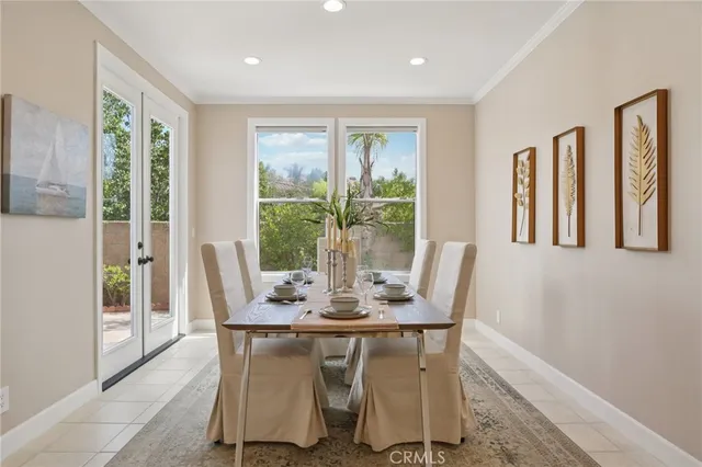 a dining room with furniture a rug and wooden floor