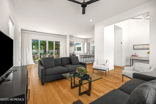a view of a livingroom with furniture and kitchen view