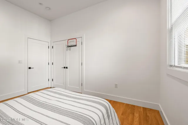 a view of a room with wooden floor and furniture