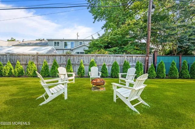 a aerial view of a house with a yard table and chairs