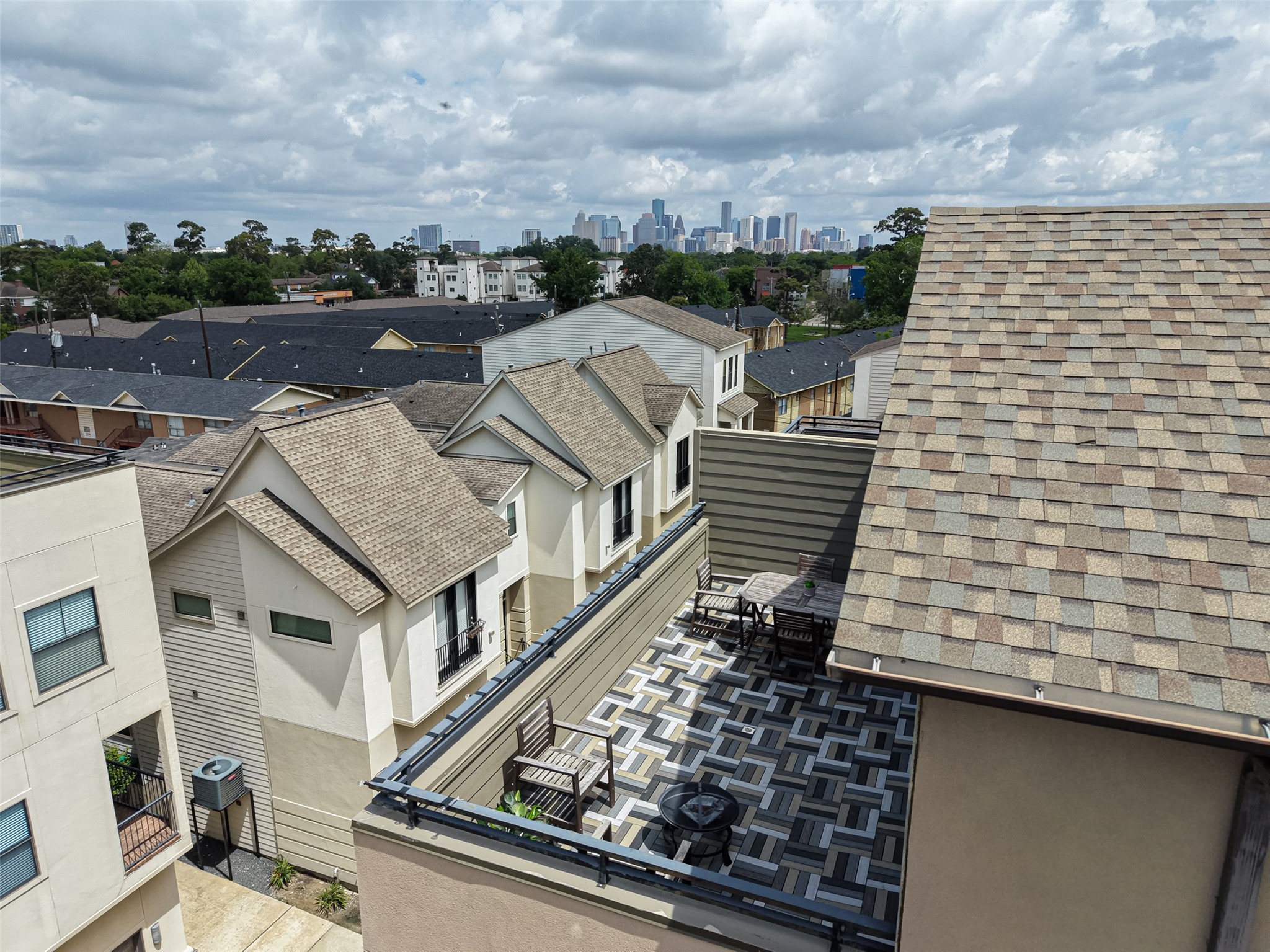 2611 Riverside Drive, Unit C Houston, TX 77004 - Photo 50 of 50 Modern townhome with a spacious rooftop patio offering city skyline views. The neighborhood features well-maintained homes and lush greenery, creating an inviting and picturesque setting.