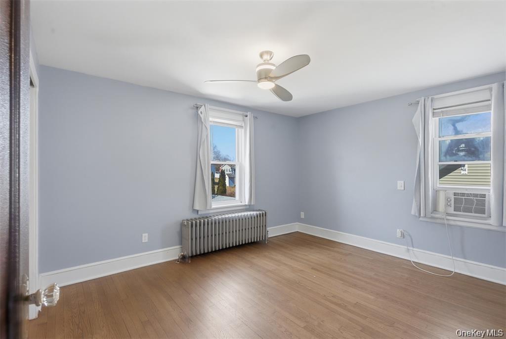 110 Innis Avenue Poughkeepsie, NY 12601 - Photo 15 of 22 a view of an empty room with a window and wooden floor