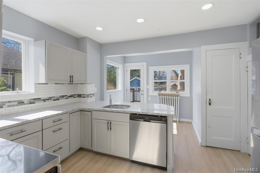 110 Innis Avenue Poughkeepsie, NY 12601 - Photo 6 of 22 a kitchen with granite countertop white cabinets and white appliances