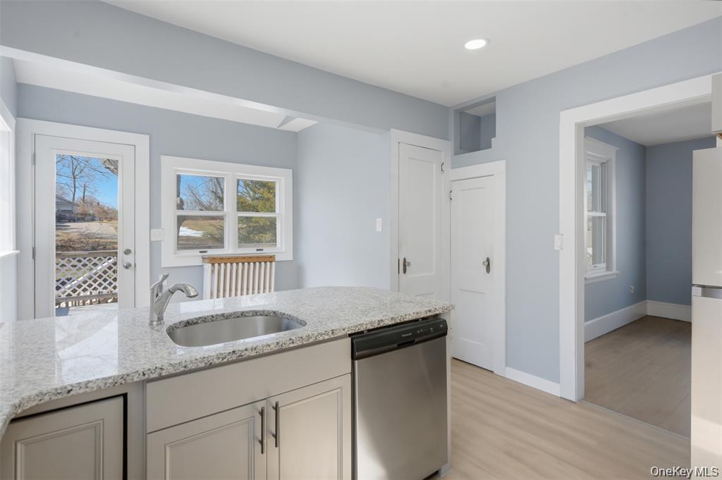 110 Innis Avenue Poughkeepsie, NY 12601 - Photo 7 of 22 a kitchen with granite countertop a sink and a white wooden cabinets
