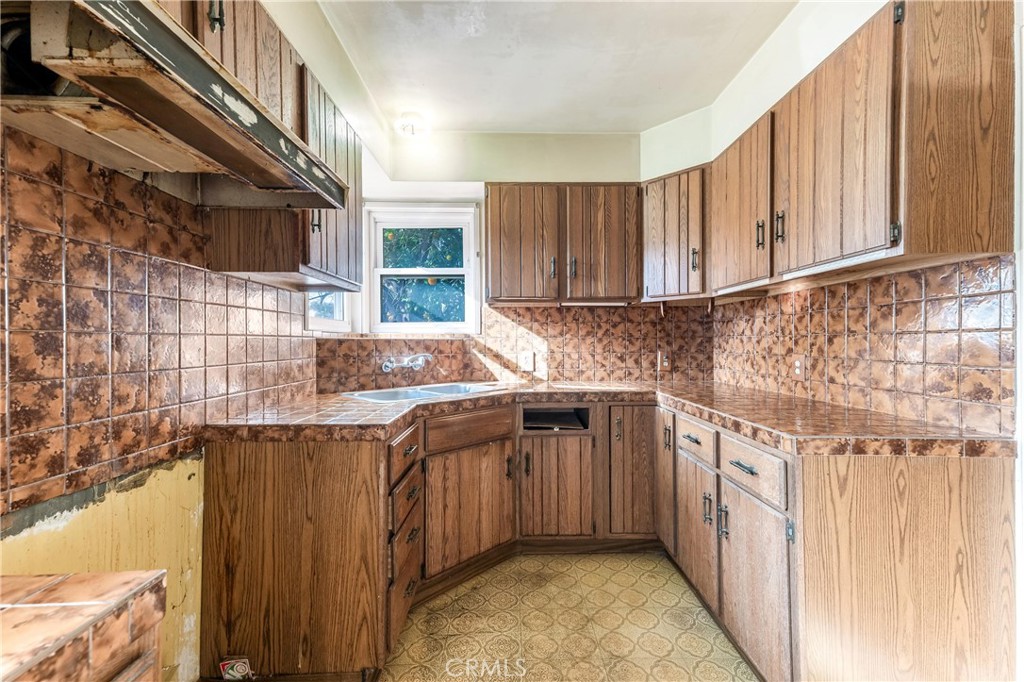 7508 Etiwanda Avenue Reseda, CA 91335 - Photo 12 of 32 a kitchen with stainless steel appliances granite countertop a sink stove and cabinets