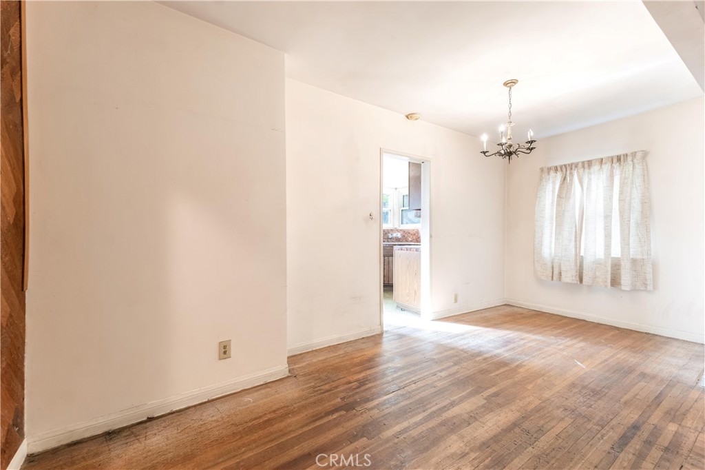 7508 Etiwanda Avenue Reseda, CA 91335 - Photo 9 of 32 an empty room with wooden floor and windows
