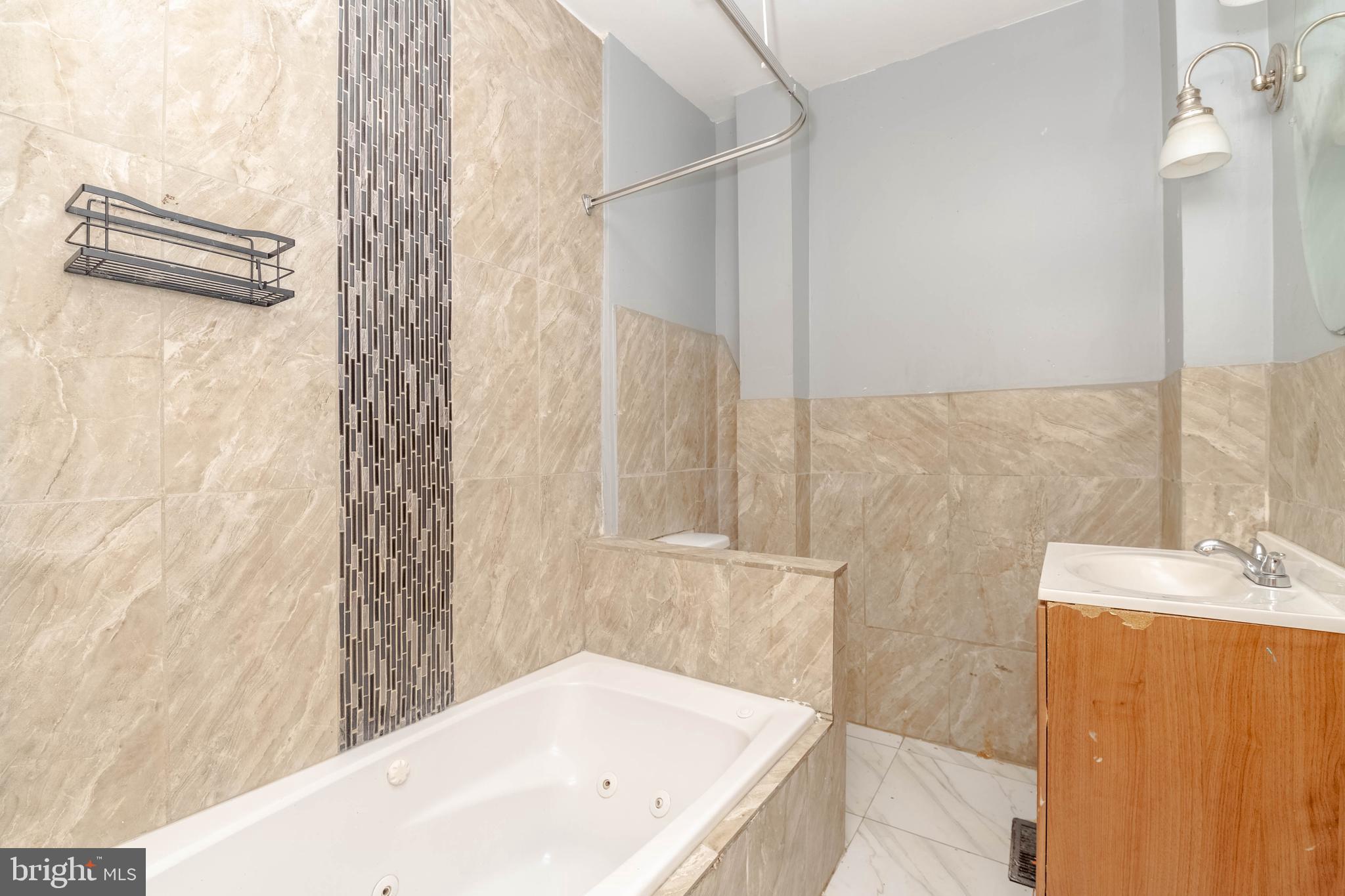 2216 West Fayette Street Baltimore, MD 21223 - Photo 24 of 36 a bathroom with a bathtub and shower