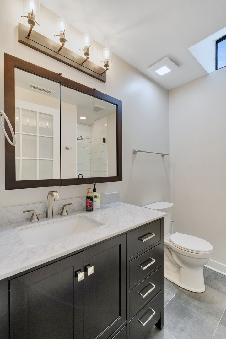 650 West Wayman Street, Unit 508 Chicago, IL 60661 - Photo 11 of 23 a bathroom with a double vanity sink and a mirror