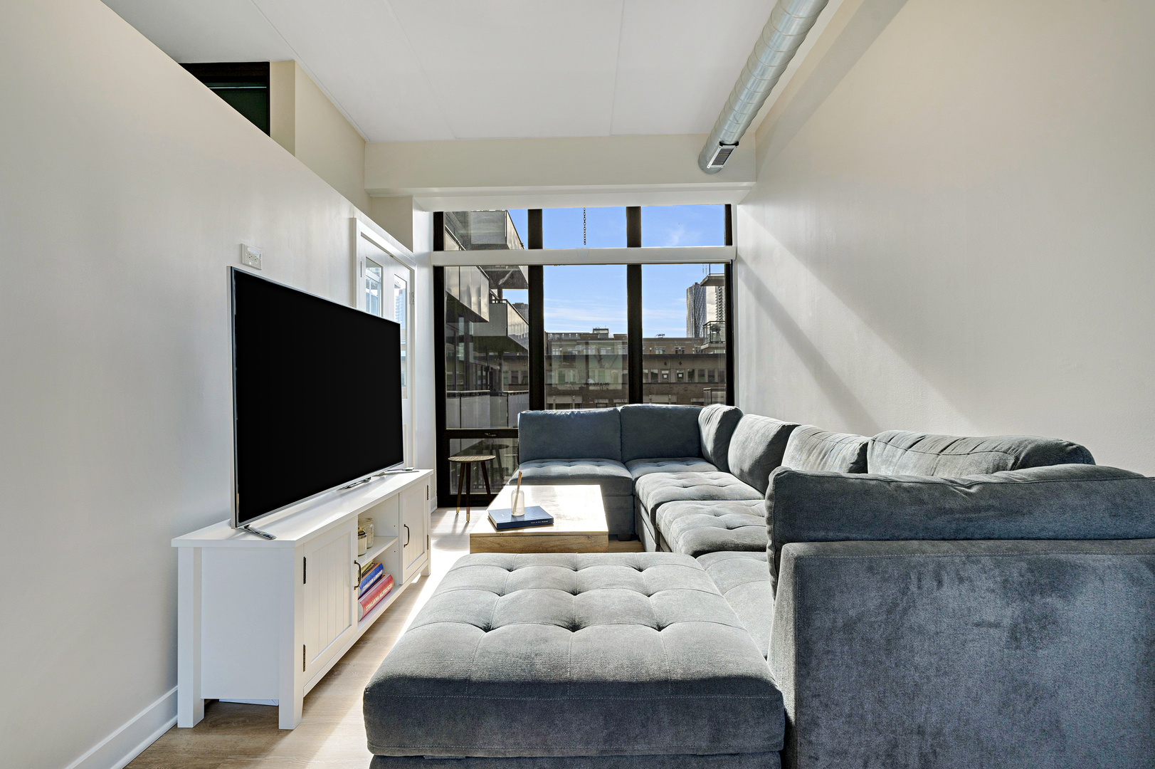 650 West Wayman Street, Unit 508 Chicago, IL 60661 - Photo 6 of 23 a living room with furniture and a flat screen tv