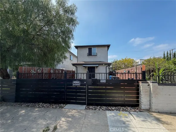 a view of a house with a fence