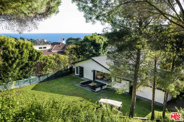a aerial view of a house with swimming pool garden and patio