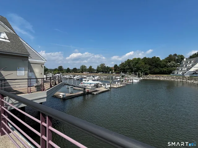 a view of swimming pool with outdoor seating and lake view