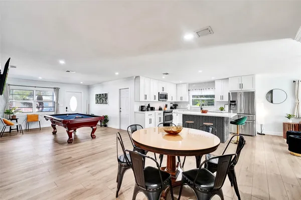 a view of a dining room with furniture and wooden floor