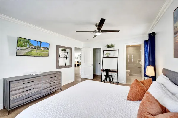 a bedroom with a bed and a dresser