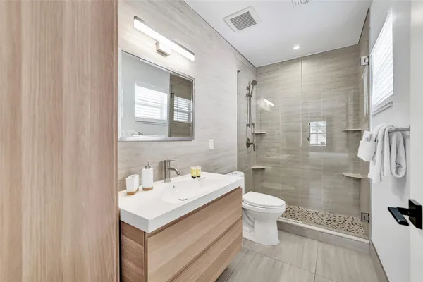 a bathroom with a sink toilet and shower