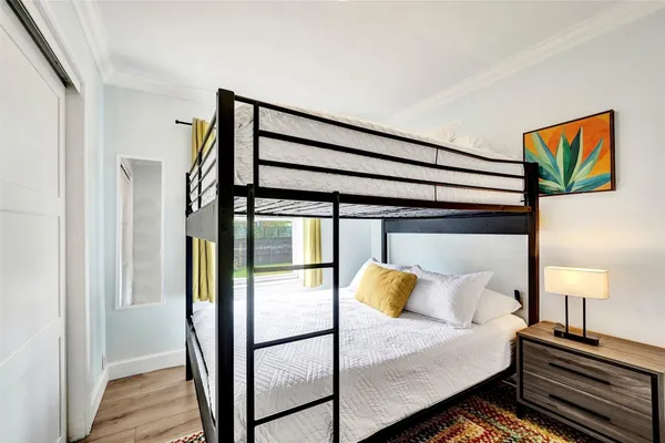 a bedroom with a bed and wooden floor