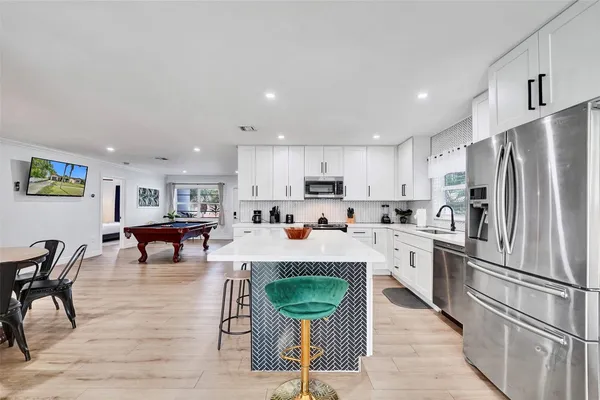 a kitchen with refrigerator and cabinets
