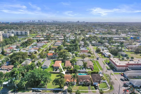 an aerial view of residential houses with city view