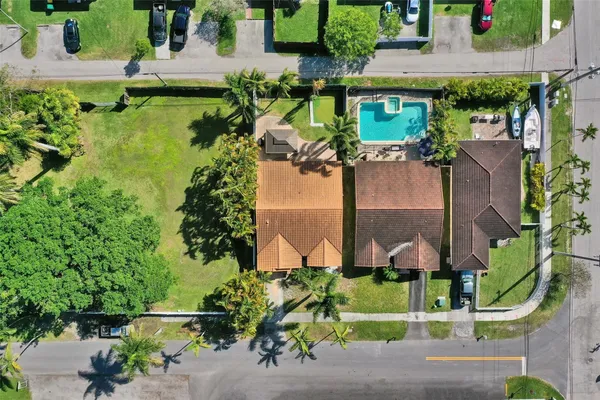 an aerial view of a house with a yard basket ball court and outdoor seating