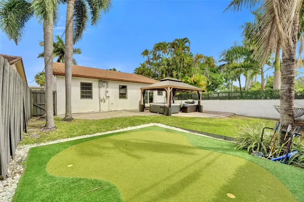 a swimming pool with outdoor seating and yard