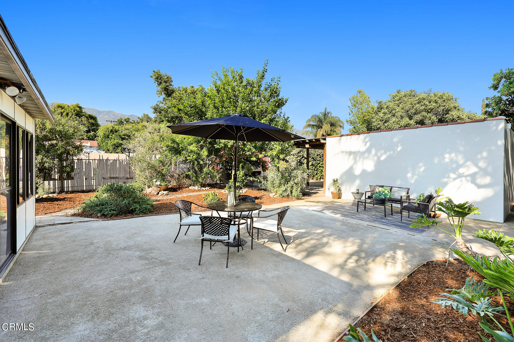 2864 Sterling Place Altadena, CA 91001 - Photo 18 of 28 a view of a patio with table and chairs under an umbrella