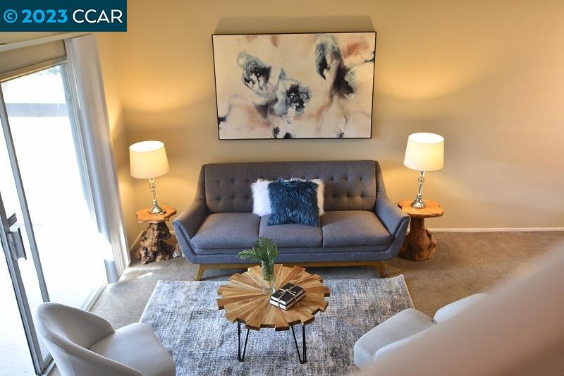 a living room with furniture and a lamp