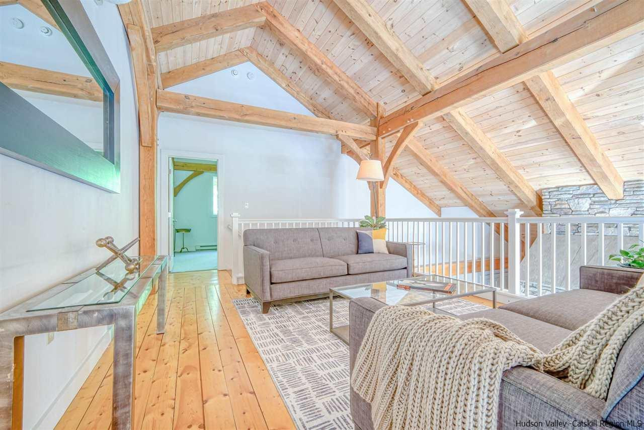 215 Sheldon Hill Road Olivebridge, NY 12461 - Photo 24 of 32 a bedroom with a bed couch and a large window with wooden floor