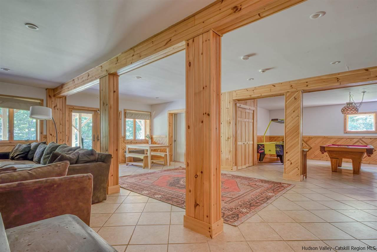 215 Sheldon Hill Road Olivebridge, NY 12461 - Photo 25 of 32 a living room with furniture and a dining table next to a large window