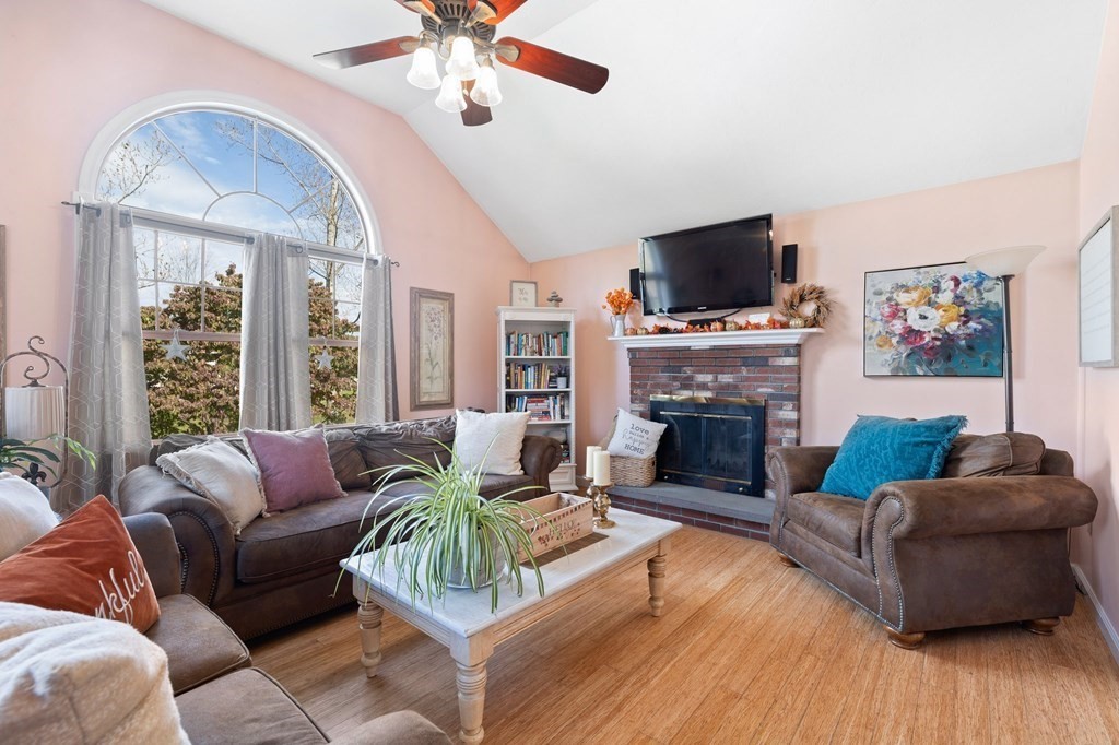 5 Kayla Lane Dudley, MA 01571 - Photo 8 of 32 a living room with furniture a flat screen tv and a fireplace
